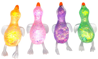 Four glitter-filled squeeze goose toys in orange, pink, purple, and green with white feet and orange beaks