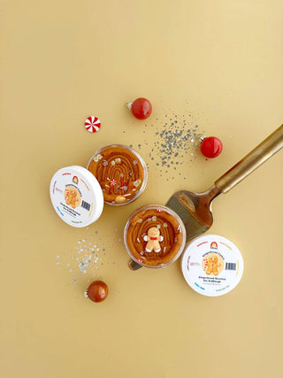 Gingerbread-scented brown play dough in clear containers with gingerbread man toppers and holiday decorations