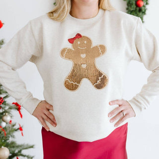 Cream sweatshirt with sequin gingerbread girl patch and red bow