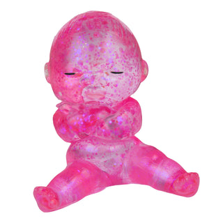 Pink baby figurine with a textured surface on a white background