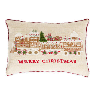 Cream embroidered pillow featuring gingerbread train with Merry Christmas text and red pom-pom trim