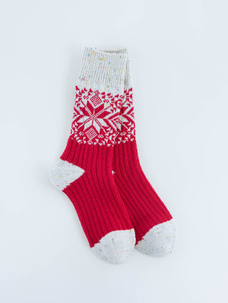 Red and white patterned sock on a light gray background