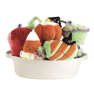 Halloween plush stuffed toys in woven basket featuring candy corn pumpkin and monster characters
