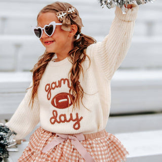 Pink gingham tiered tulle tutu skirt with pink satin bow on girl