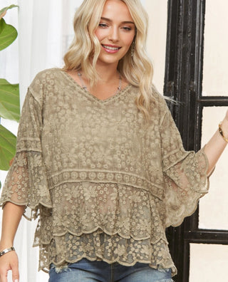 Woman wearing khaki crochet detail 3/4 sleeve top with tiered lace trim
