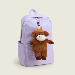 Warmies Highland Cow plush bag charm clipped to lavender backpack zipper
