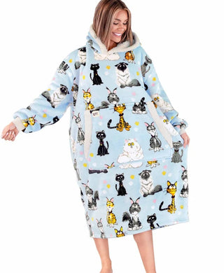 Woman wearing oversized light blue hoodie blanket with cartoon cat print pattern