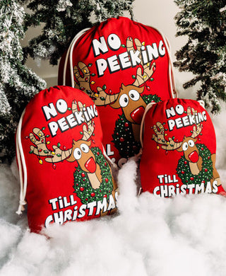 Three red cotton Christmas gift bags with No Peeking Till Christmas reindeer print