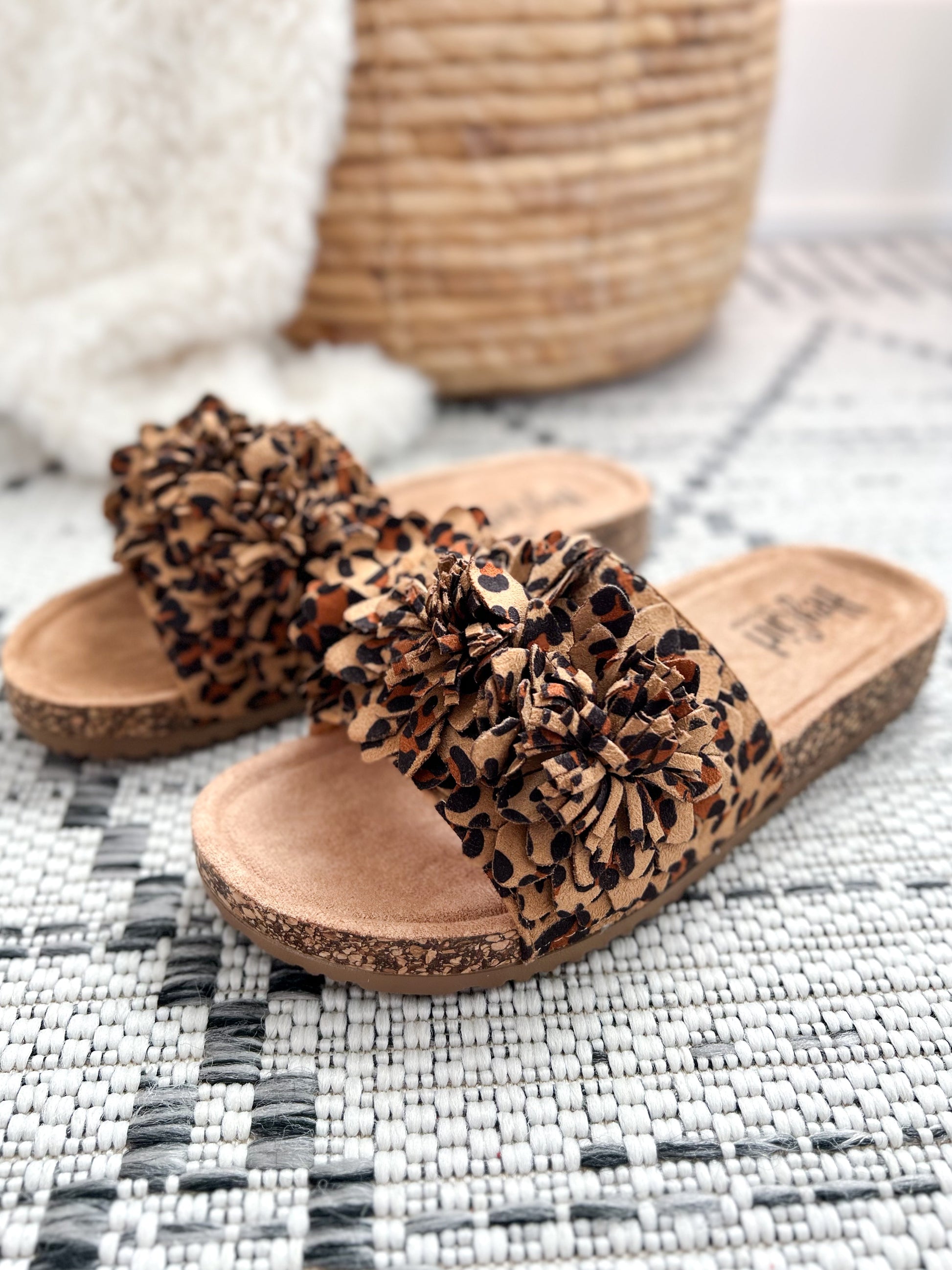 Corkys Wild Child leopard print slide sandals with decorative pom poms on cork sole