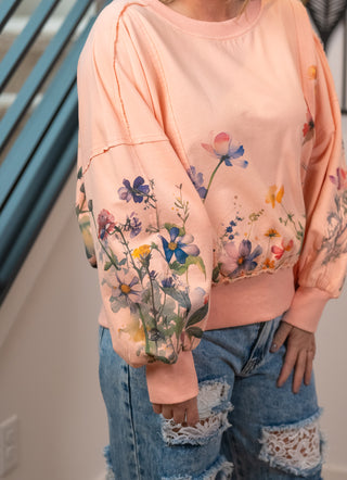 close up of the dolman sleeves featuring lots of flowers