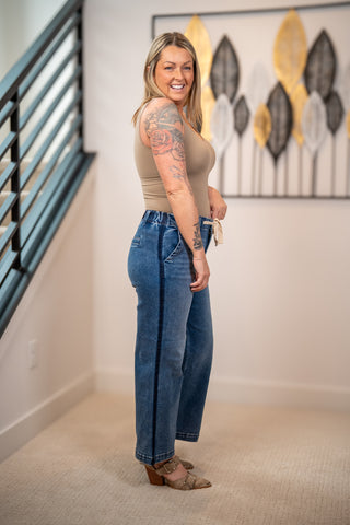 Side view of Risen elastic band high rise cropped wide leg jeans with drawstring waistband and relaxed fit