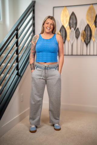 Risen slouchy barrel leg contrast denim detail pants with drawstring waist front view styled with blue textured crop tank