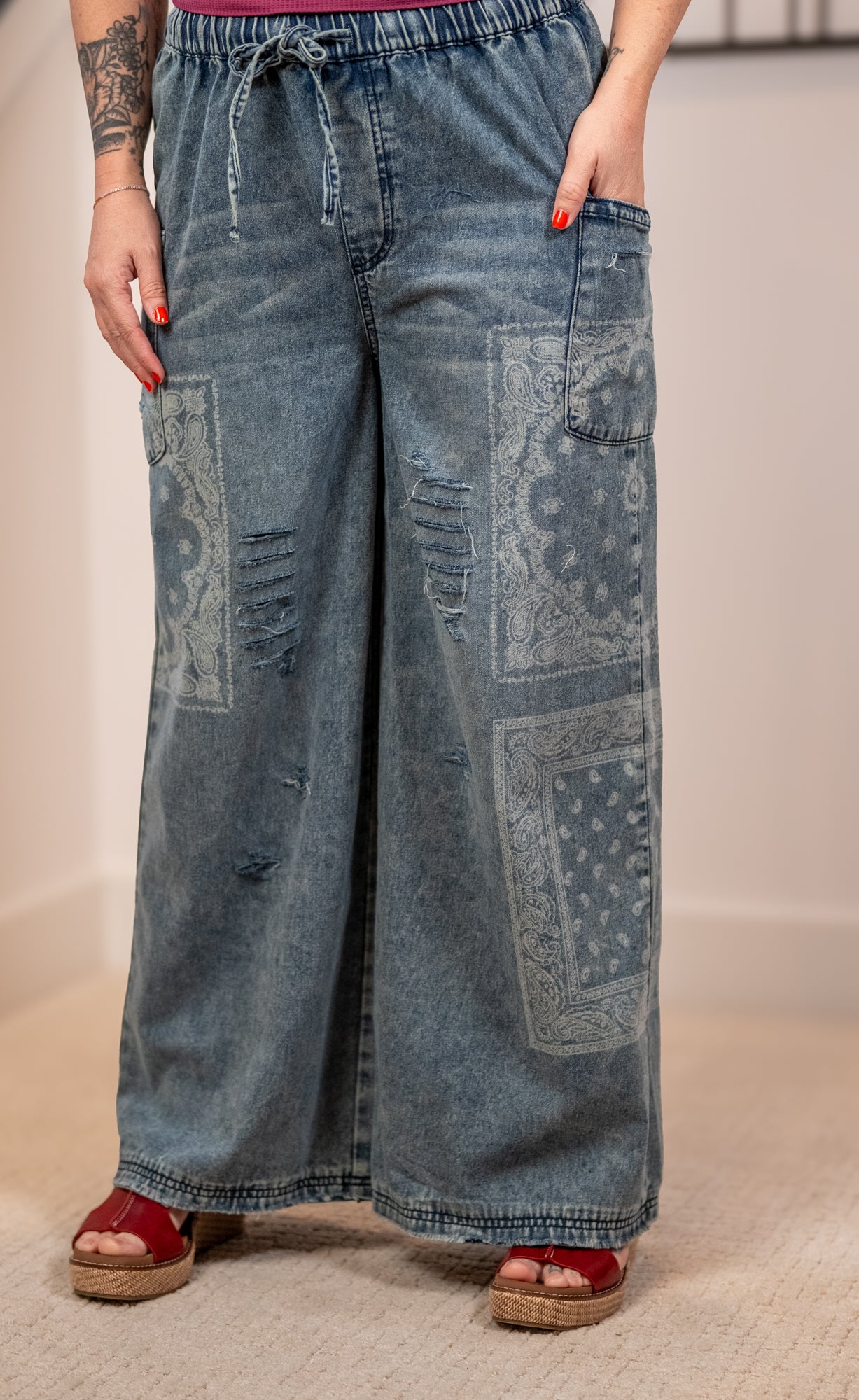 Wide-leg jeans with patchwork design worn by a person on a neutral background