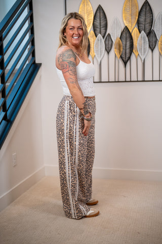 Woman standing in a room with decorative wall art in the background
