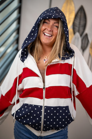 Person wearing a hoodie with an American flag design