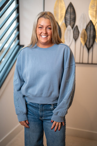HYFVE light blue crewneck sweatshirt with star patch sleeve details on model