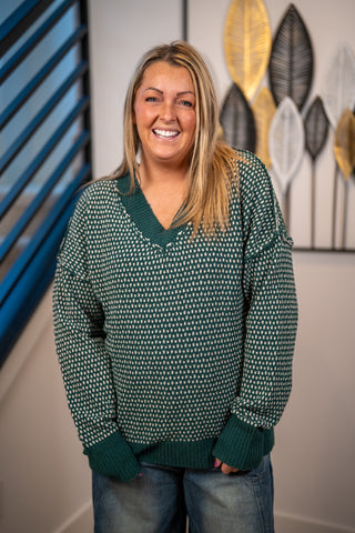 Green and cream contrast knit V-neck sweater with textured pattern and ribbed cuffs