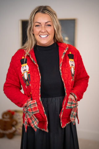 Red quilted jacket with nutcracker embroidery and plaid bow trim details