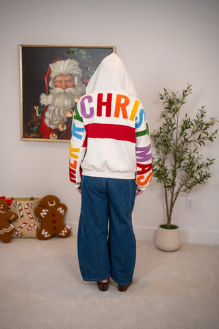 White zip-up hoodie with colorful Merry Christmas letters on back and sleeves