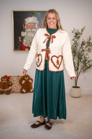 Cream quilted jacket with plaid bow ties, heart pockets, and gingerbread man appliqués