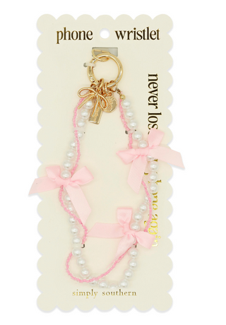 Pink beaded phone wristlet with bow charm on a 'simply southern' branded card.