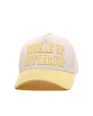 A structured baseball cap with a cream-colored crown and a pale yellow brim, featuring the words 'BUCKLE UP BUTTERCUP' embroidered in yellow on the front.